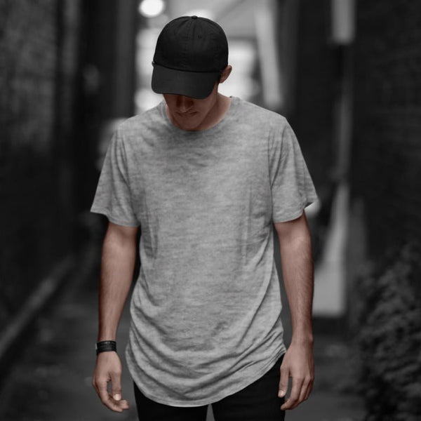 Takeincart cotton longline T shirt heather gray worn by male model with black cap in alley summer print vest