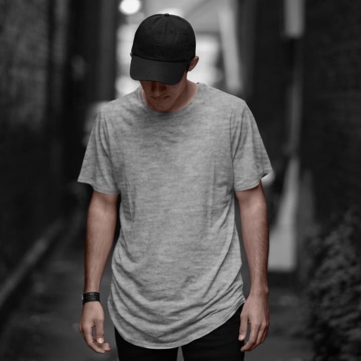 Takeincart cotton longline T shirt heather gray worn by male model with black cap in alley summer print vest