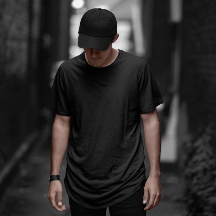 Takeincart cotton longline T shirt black on male model in urban alleyway casual summer print vest
